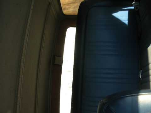 1979 Ford Bronco - The interior of this 1979 Ford Bronco features blue vinyl seats and textured door panels.