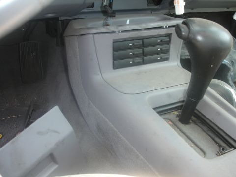 1993 Ford Taurus - Interior view of a 1993 Ford Taurus, highlighting the center console with gear shifter and cassette storage.