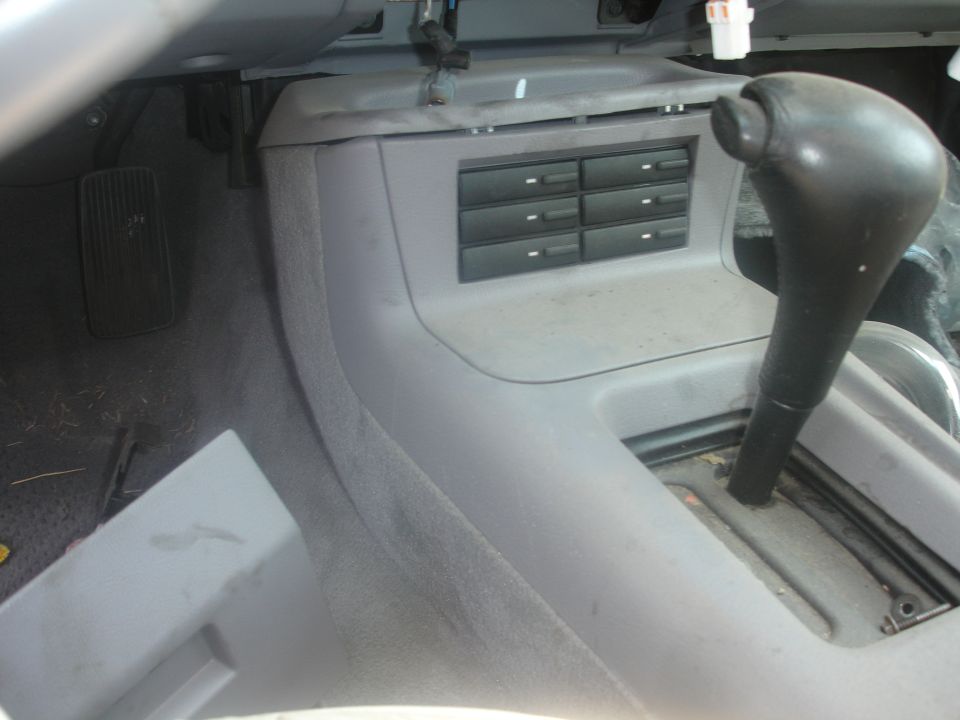 1993 Ford Taurus interior showing automatic gear shifter and six-cassette storage unit