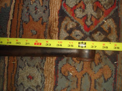1992 Ford Bronco - A metal pipe is shown with a yellow tape measure indicating its length.