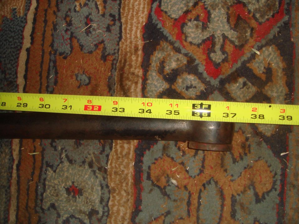 metal pipe measured with tape measure showing 32 to 39 inches