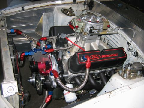 1992 Ford Mustang - Close-up of a modified engine with prominent Ford Racing branding and custom plumbing.