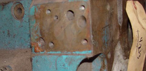 1969 Ford Fairlane - A close-up view of a metal component, showing rust and teal paint, with a tag bearing handwritten numbers.