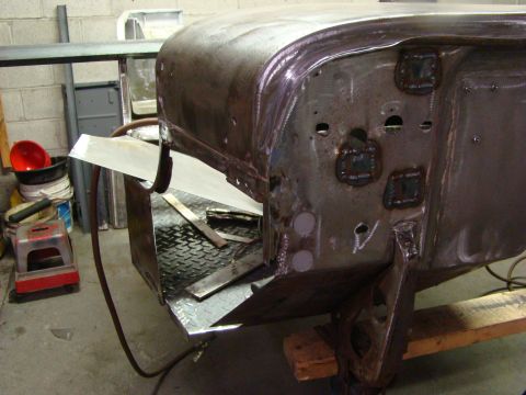 1948 Jeep Wrangler - This unfinished vehicle body panel shows signs of repair and modification, with no clear year identification.