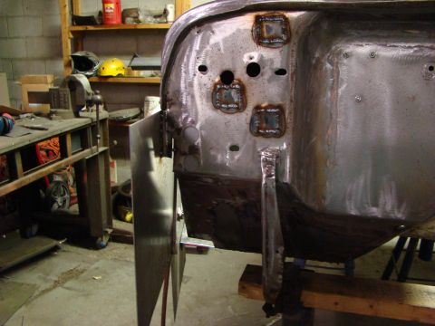 1948 Jeep Wrangler - Vehicle body panel shows fresh welds and metalwork in a workshop setting.