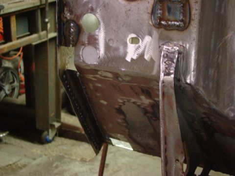 1948 Jeep Wrangler - Metal body panel repair shows extensive welding and grinding work on a vehicle's chassis.