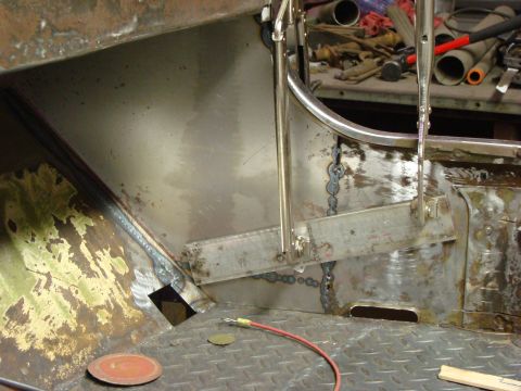 1948 Jeep Wrangler - Close-up view of the interior bodywork of a vehicle undergoing repairs, with various tools visible in the background.