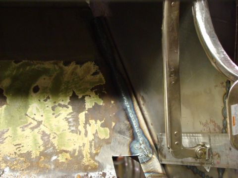 1948 Jeep Wrangler - Close-up of welding on a metal panel showing discoloration and repair work.