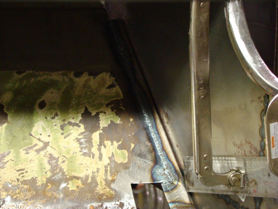 Welding on discolored metal panel with green and brown patches