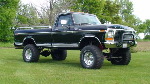 1979 Ford F-250 - Lifted 1979 Ford F-250 pickup truck with chrome accents and a bull bar on the front.