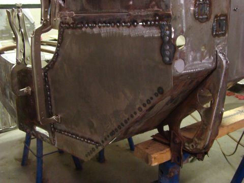 1948 Jeep Wrangler - Metal body panels are being welded together during a vehicle repair process.