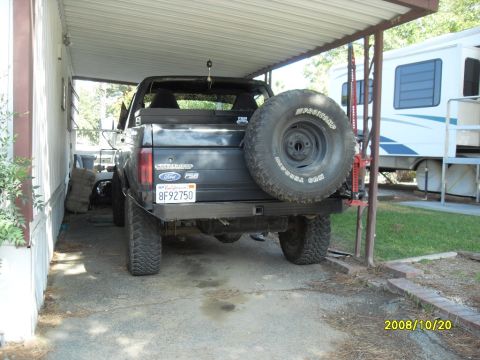 1990 Ford Bronco - This 1990 Ford Bronco is parked under a carport, a rear-mounted spare tire and a custom bumper.