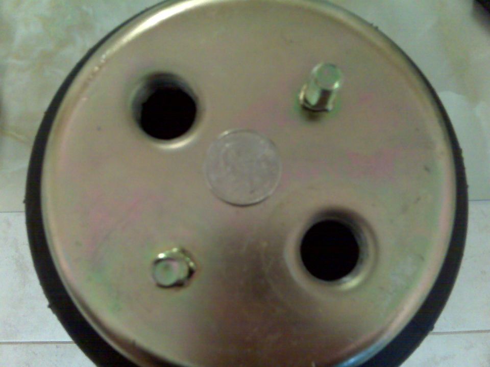 Gold zinc-plated end plate of an air spring with two mounting studs and holes, black rubber bellows around edge