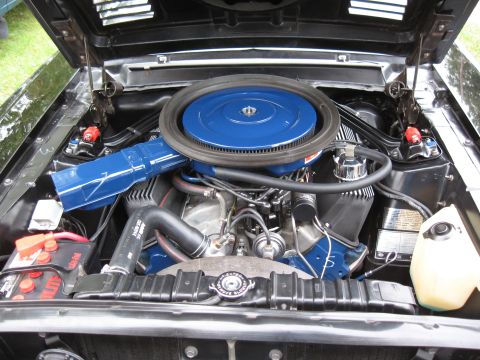 1968 Shelby GT500 - Close-up view of a V8 engine bay, a prominent blue air cleaner and various engine parts.