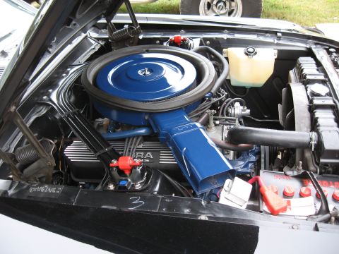 1968 Shelby GT500 - The engine bay of a 1968 Shelby GT500 shows its powerful V8 engine with distinctive blue accents.