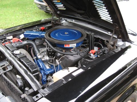 1968 Shelby GT500 - Detailed view of the engine compartment in a black 1968 Shelby GT500, highlighting the blue air cleaner and distinctive Cobra valve covers.