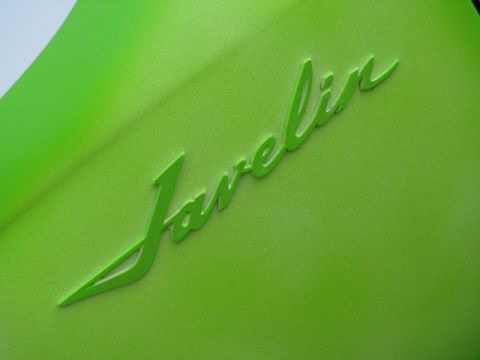 1978 AMC Javelin - Close-up of a green Javelin emblem on a car's body panel.