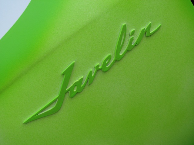 Lime-green 'Javelin' cursive emblem on a curved green body panel