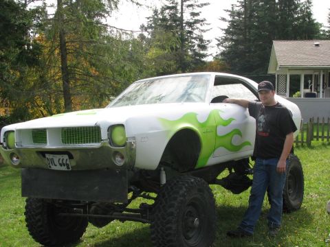 1978 AMC Javelin - This heavily modified car, likely from the early 1970s, features a lifted suspension and custom flame paintwork.