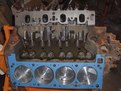 1978 Ford Bronco - Close-up view of an engine block assembly, pistons and a cylinder head, likely during a rebuild or upgrade process.