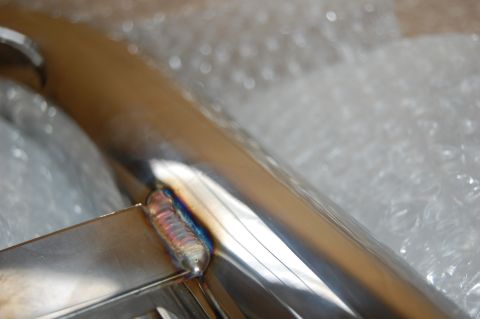 2002 BMW M3 - A close-up view of a polished metal pipe, showing a welded joint and wrapped in protective bubble wrap.
