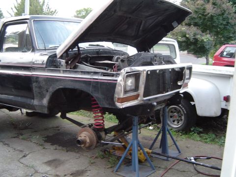 1979 Ford Bronco - This truck is undergoing repairs with its front end disassembled and supported on jack stands.