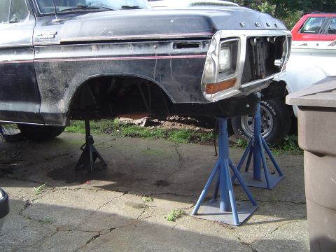 1979 Ford Bronco - Front end of a 1979 Ford Bronco is raised on jack stands for repair or restoration.