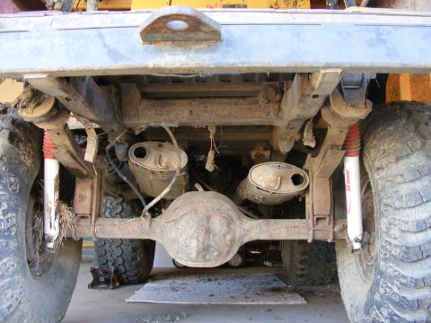 1974 Ford Bronco - Vehicle's rear undercarriage with dual exhaust system and suspension components visible.