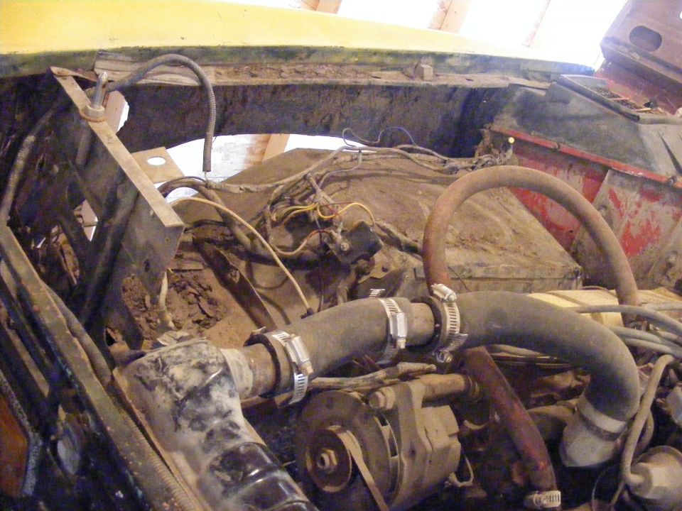 Engine bay with hoses and wiring visible