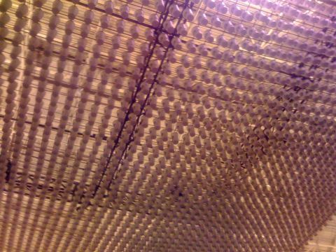 1994 Ford Bronco - A ceiling covered in rows of hanging white objects, creating a patterned effect with shadows.