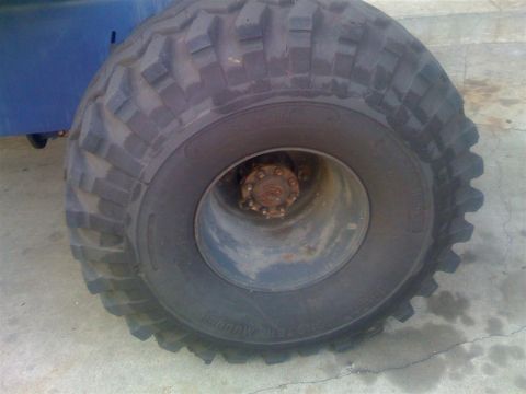 1994 Ford Bronco - A close-up view focuses on the tread of a large vehicle tire and its central hub assembly.