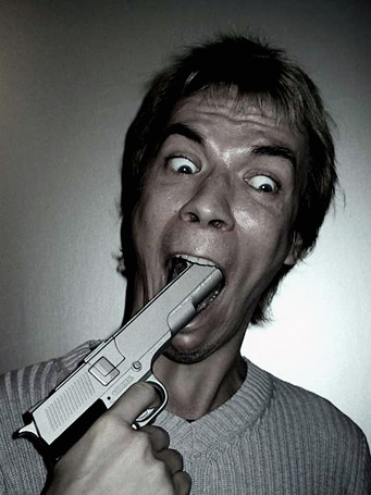 1991 Ford Bronco - A man's face is contorted in a shocked expression as he holds a handgun in his mouth.