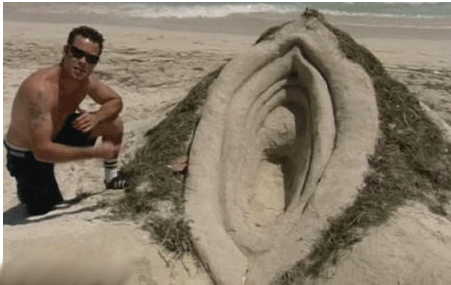 1996 Ford Bronco - A man poses with a large sand sculpture on a beach, decorated with seaweed.