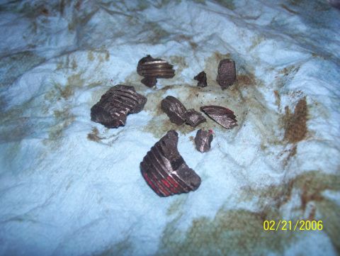 1978 Ford Bronco - Several pieces of damaged metal gears are scattered on a stained blue cloth, likely from a differential.