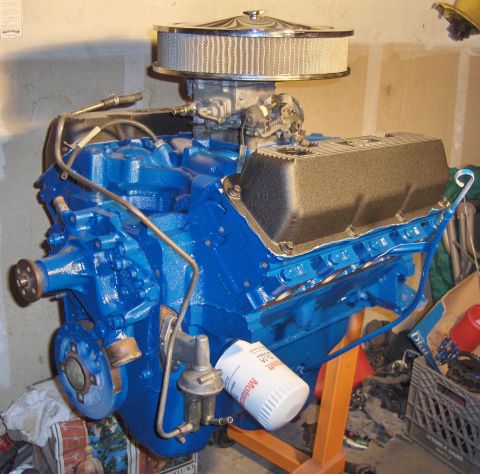1978 Ford Bronco - A freshly painted blue V8 engine sits on an orange stand, ready for installation.