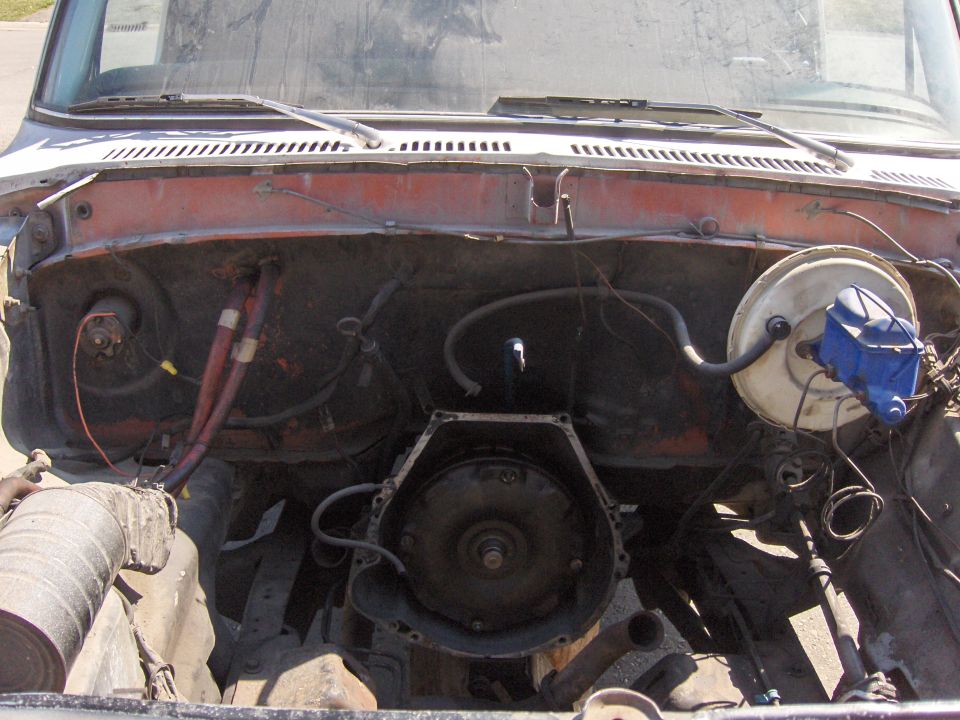 Vehicle engine bay with transmission removed, showing brake booster and master cylinder