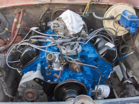 1978 Ford Bronco - Engine bay with a newly painted blue engine block and various engine components visible.