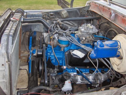 1978 Ford Bronco - Close-up view of a vehicle's engine bay, showing various components and blue paint accents.
