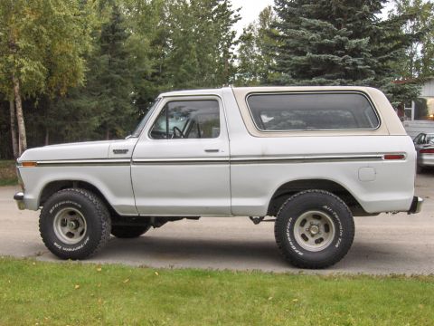 1978 Ford Bronco - Side profile of a white 1978 Ford Bronco with a tan removable top, equipped with BFGoodrich All-Terrain T/A tires.