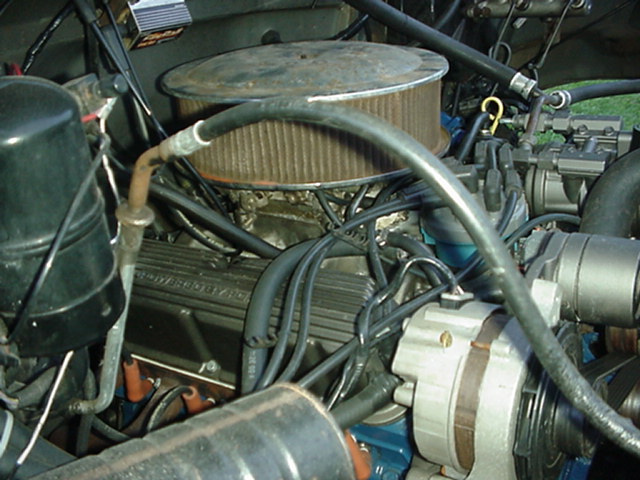 V8 engine bay with round air cleaner, plug wires and chrome alternator