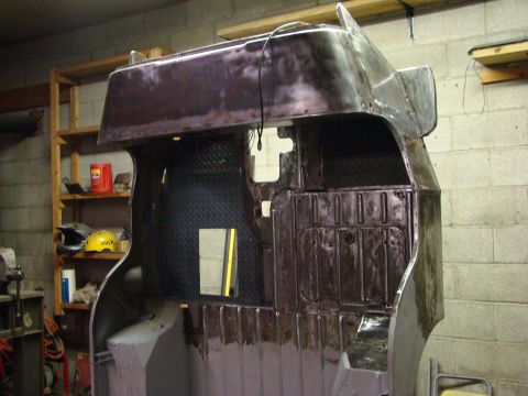1948 Jeep Wrangler - The interior of a Jeep CJ-5 body tub is visible, diamond plate flooring and metal panels, during a restoration process.