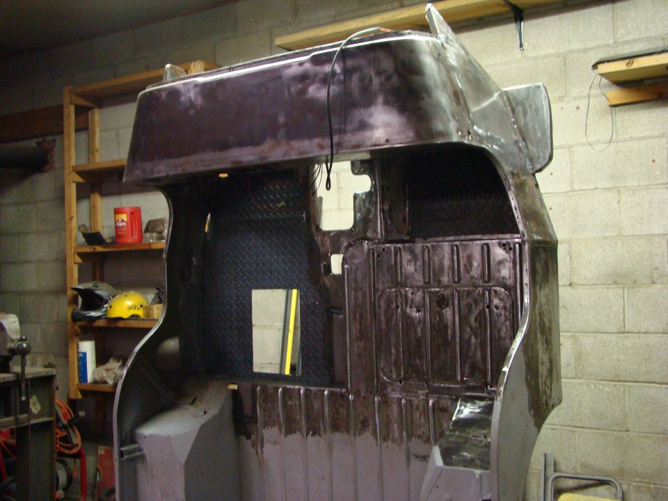 Jeep CJ-5 body tub interior, showing diamond plate flooring and metal panels, undergoing restoration