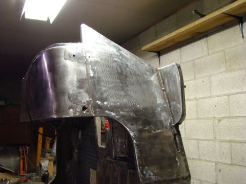 1948 Jeep Wrangler - Bare metal Jeep CJ body panel repair in progress, showing welds and grinding marks.