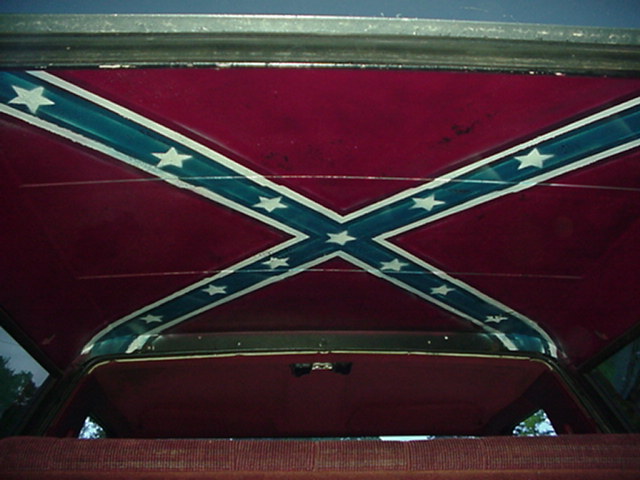 SUV headliner with Confederate flag design seen through open rear hatch