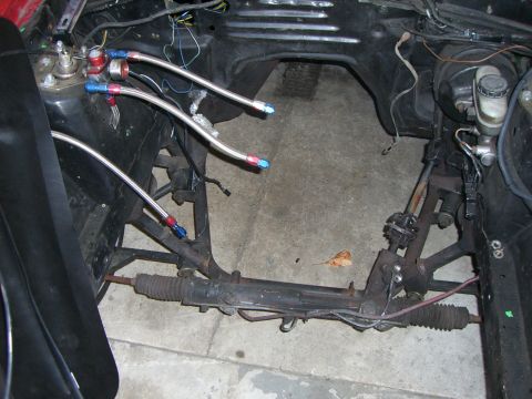 1988 Ford Bronco - Custom fuel lines and steering rack visible in an empty engine bay.
