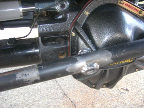 1996 Ford Bronco - Detail of a vehicle's rear axle assembly, a Dynatrac differential cover and steering components.