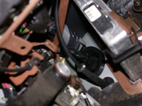 2000 Ford Crown Victoria - A detailed view of the complex mechanicals within a vehicle's interior, showing various wires and metal components.