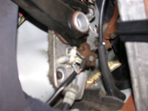 2000 Ford Crown Victoria - Close-up view of the parking brake mechanism, showing various cables and metal parts.