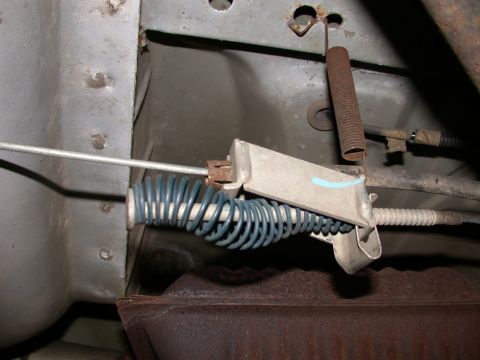2000 Ford Crown Victoria - Close-up of a parking brake cable mechanism, showing springs and bracketry.