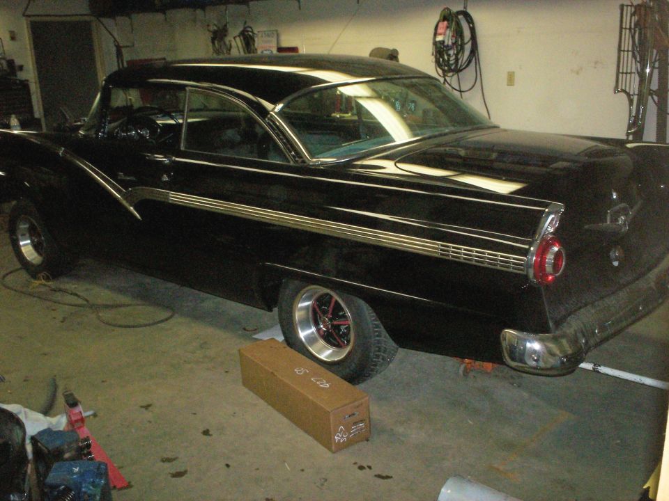 Black classic two-door hardtop car in a garage
